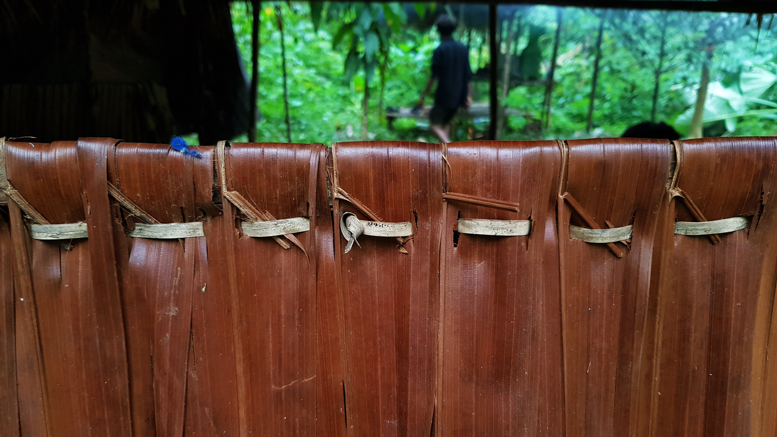 A wall of befak made of palm leaf stripes stitched together